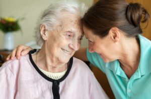 PCA providing dementia care services to elderly woman.