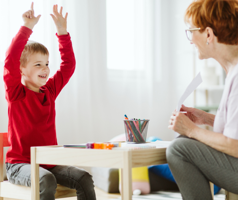 Kid with ADHD with hands raised in the hair with the teacher