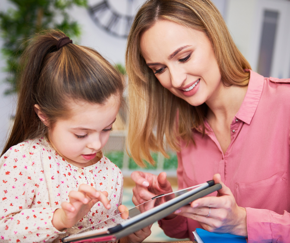 Mother playing with her daughter on a tablet