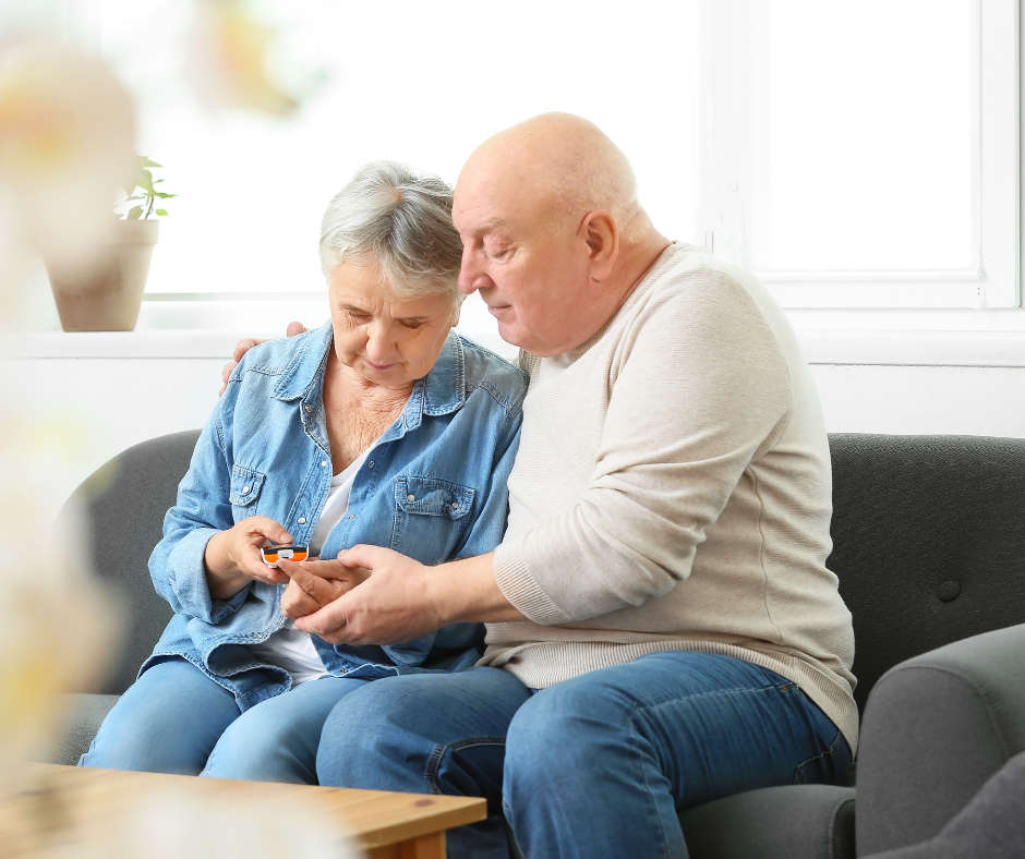 Senior couple looking at a blood sugar reading together