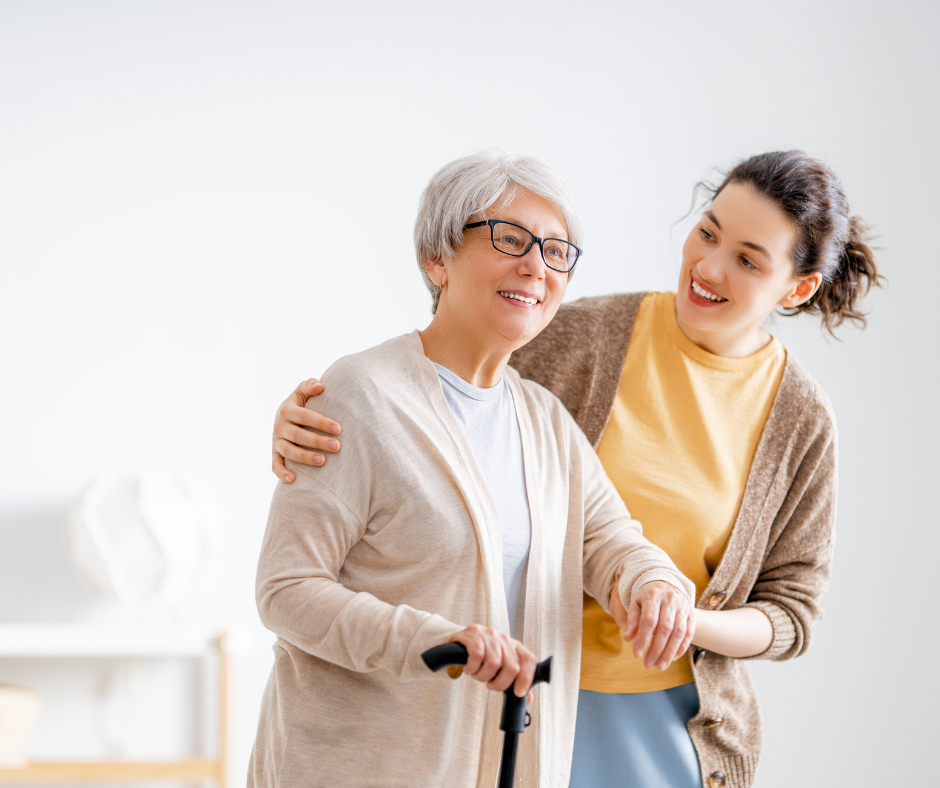 Young woman helping an older woman walk