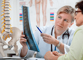 A doctor explains an x-ray to her client