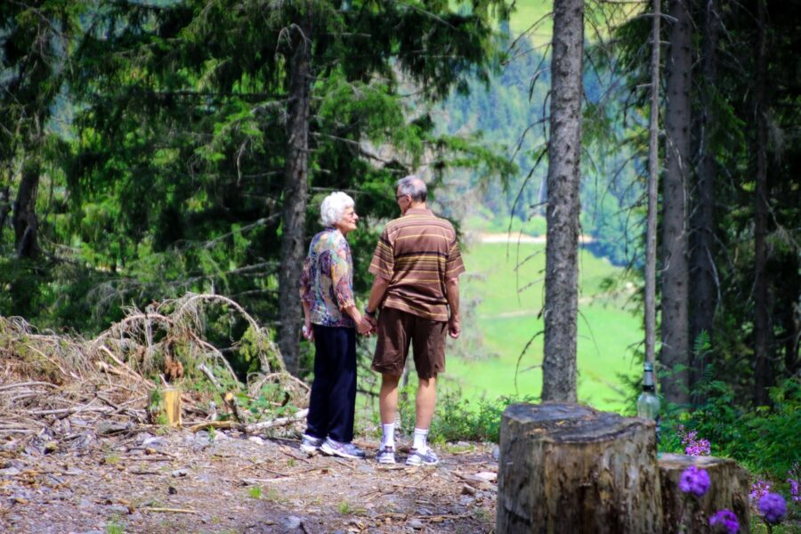An older couple exploring the woods together