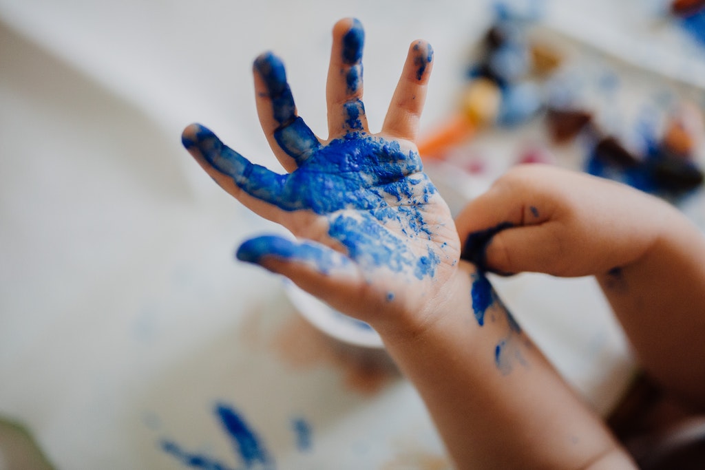 The hand of a fingerpainting kid