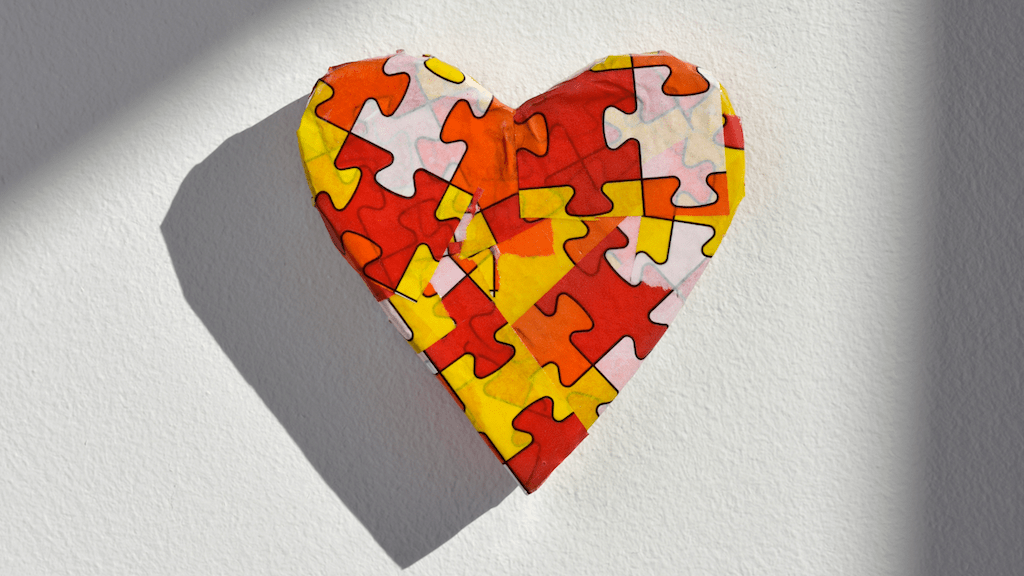 A paper mache heart with a puzzle pattern
