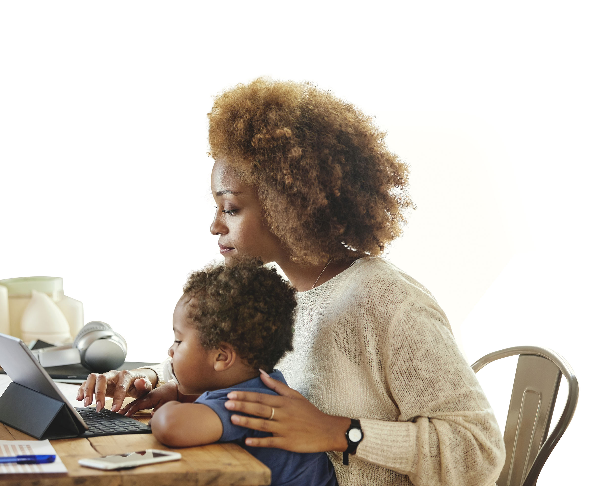 Mother with son working on digital tablet at home