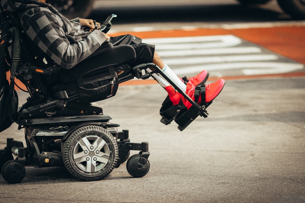 A person in a wheelchair navigates a city