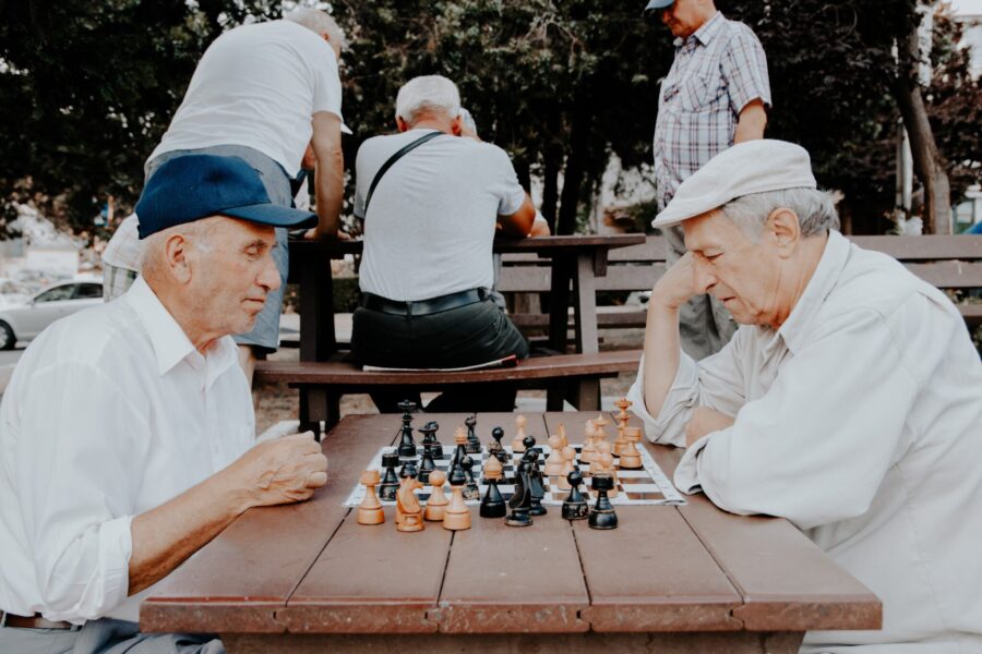 Two men compete in chess outdoors