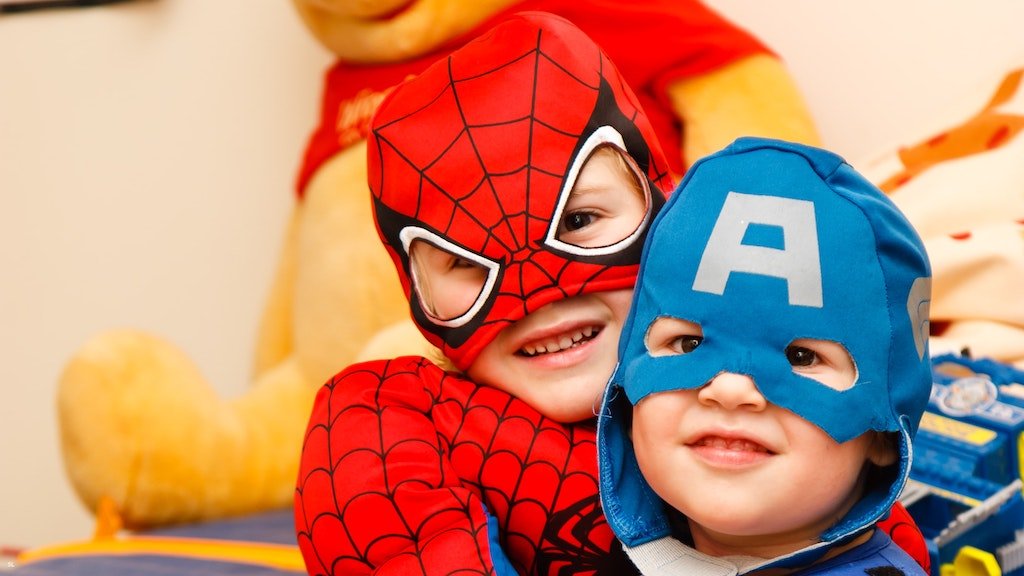 Two young brothers dressed as superheroes for Halloween.