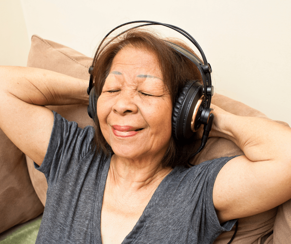A woman experiencing music therapy with headphones