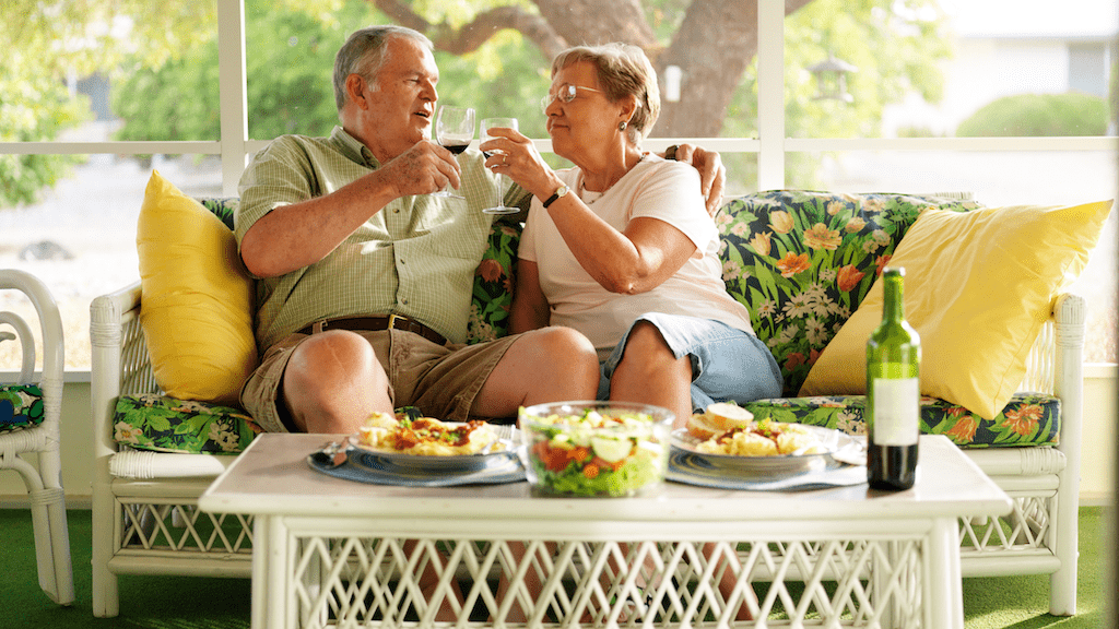 An older couple enjoying wine and dinner together