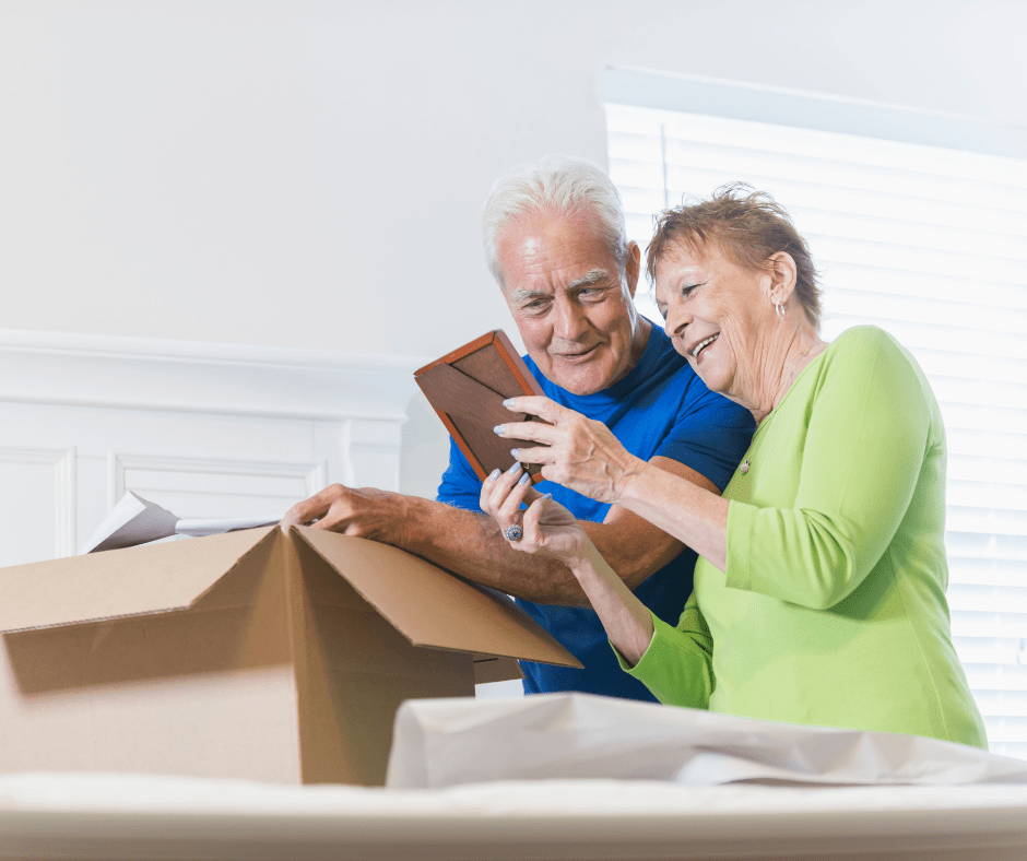 An older couple explores their boxes while moving