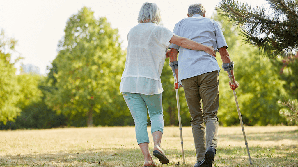 An elderly couple walking outdoors