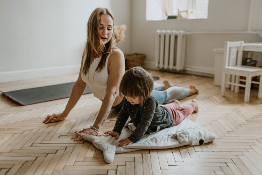 A mother doing yoga with her daughter