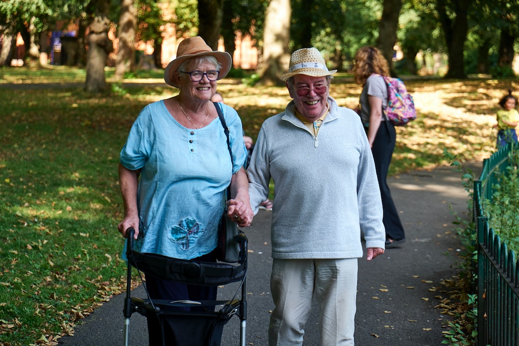 A senior couple walking in a park