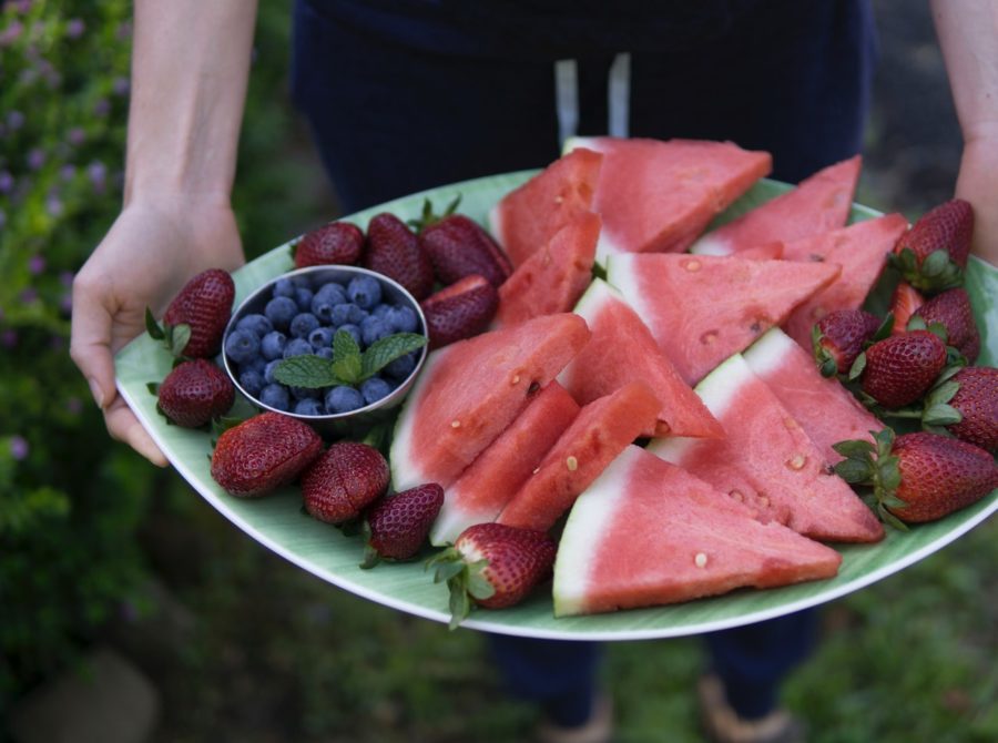 A tray that includes watermelon, strawberries, and blueberries