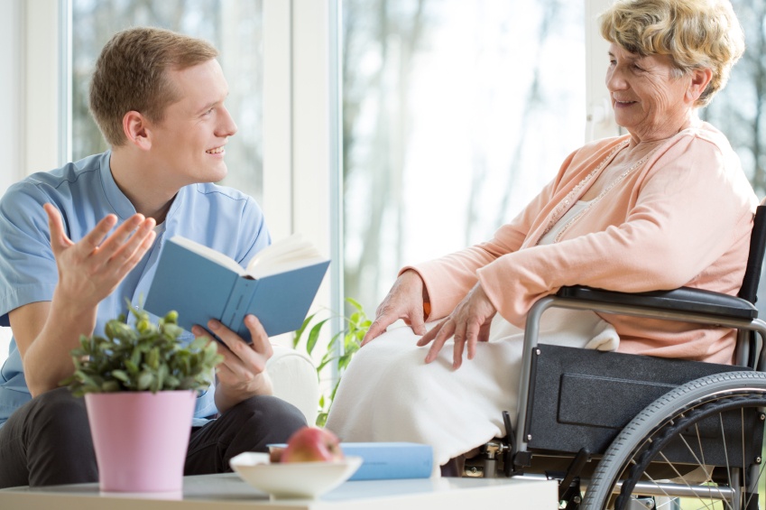 A caregiver reads to his client