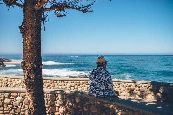 A man sits alone on the beach