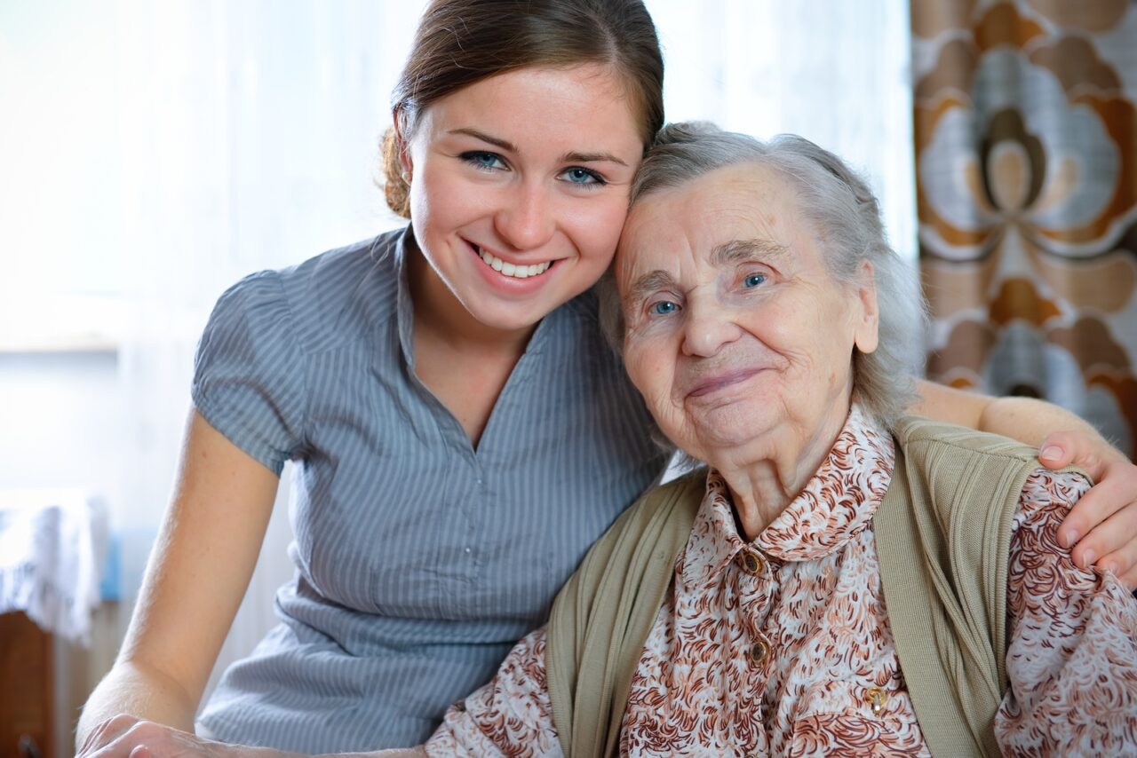 A caregiver smiles with her client