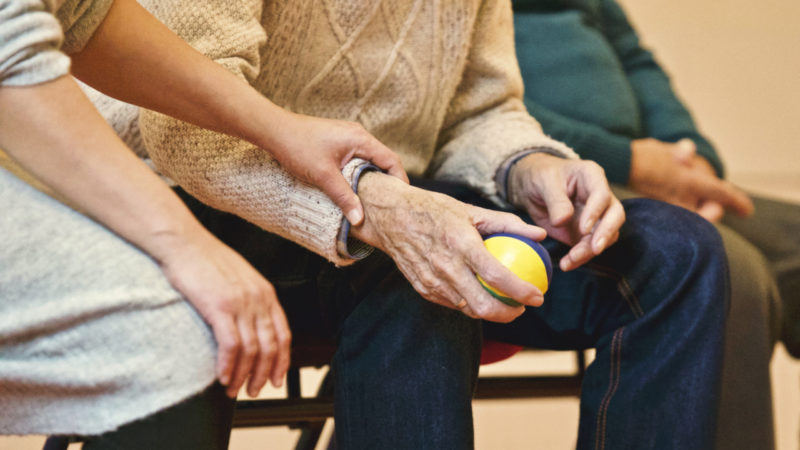 A caregiver holds the client's wrist