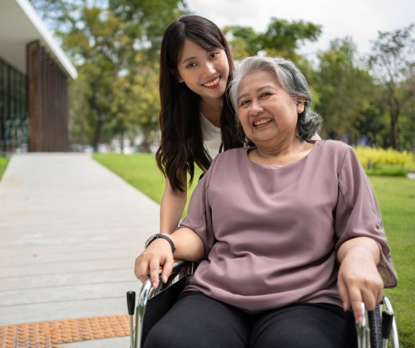 Respite care worker with her client outdoors