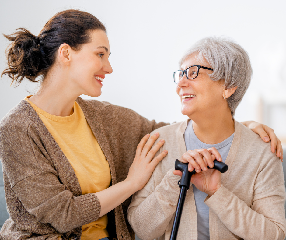 caregiver and adult patient smiling and look at eachother