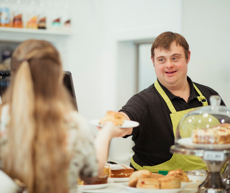 Young adult with disability working at cafe.