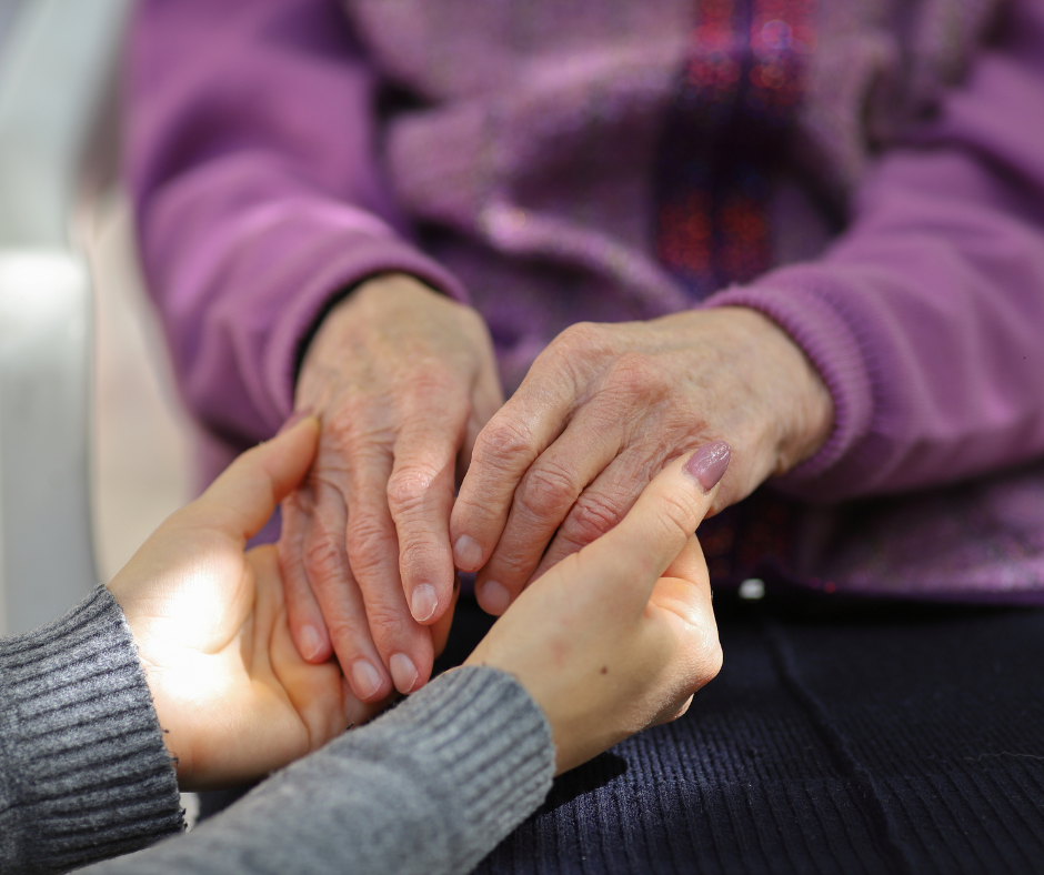 caregiver and client holding hands