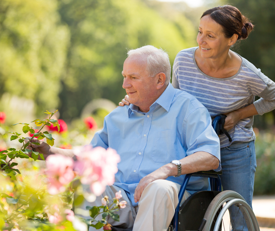 Caregiver pushing client in wheelchair