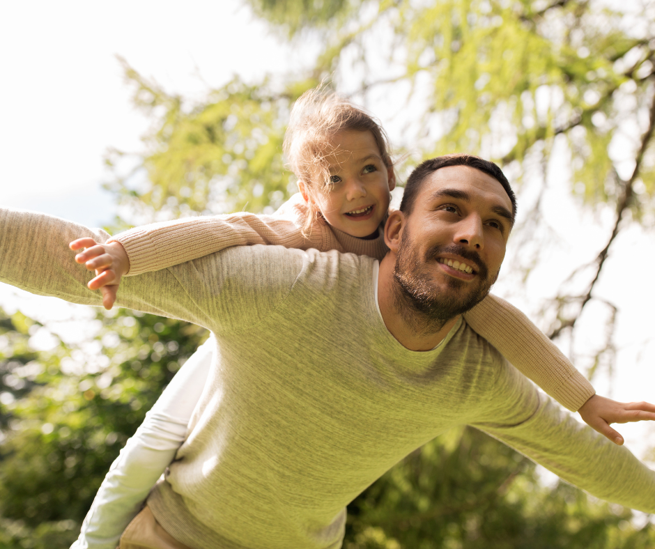 Father playing outdoors with his daughter