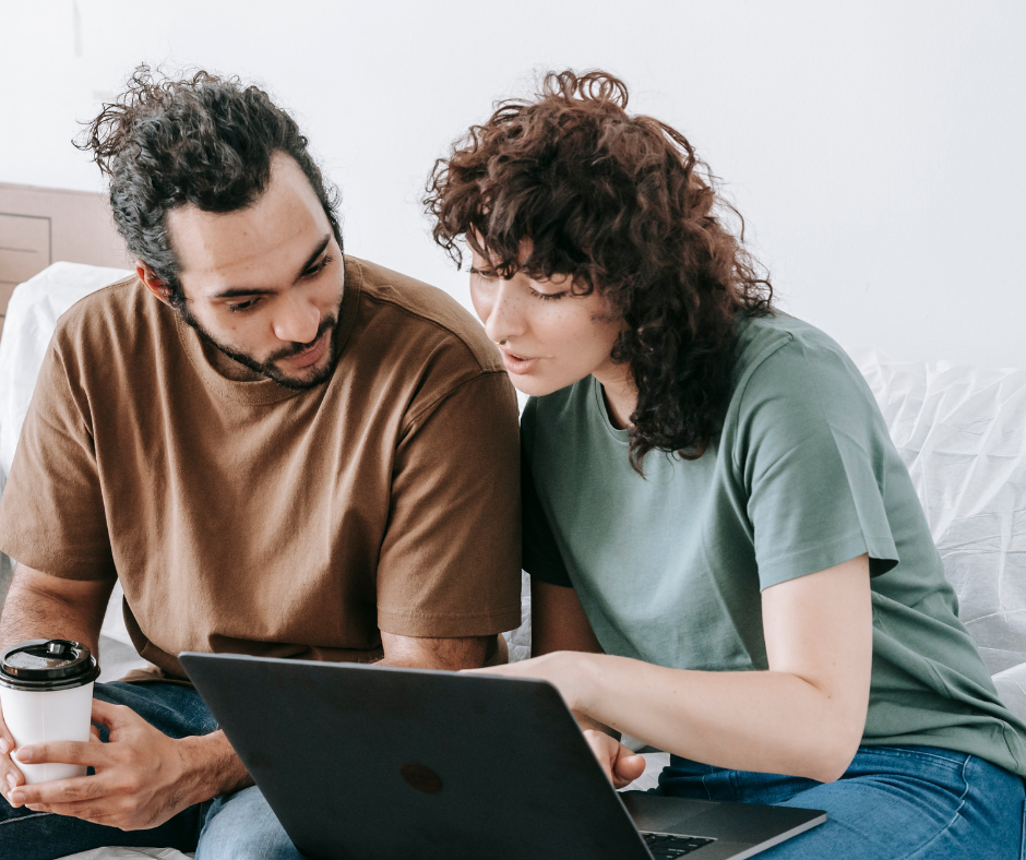 Man and woman looking at a laptop for information