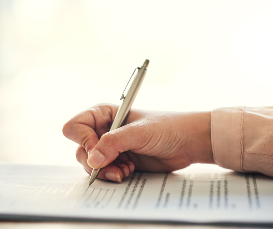 A person signing paperwork