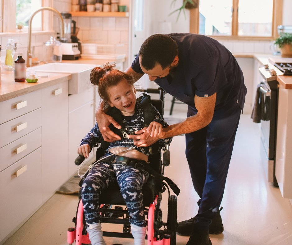 A caregiver helping a child in a wheelchair